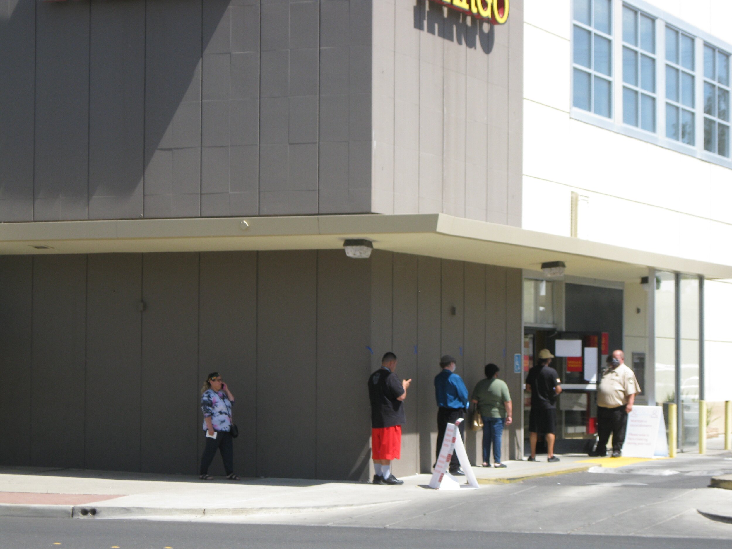 Customers wait until Wells Fargo personnel determine there is sufficient social distancing space inside the branch in downtown Merced. Photo- Steve Newvine