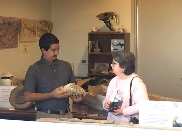 A Fossil Discovery Center volunteer shows an exhibit to a visitor. Photo: Steve Newvine)