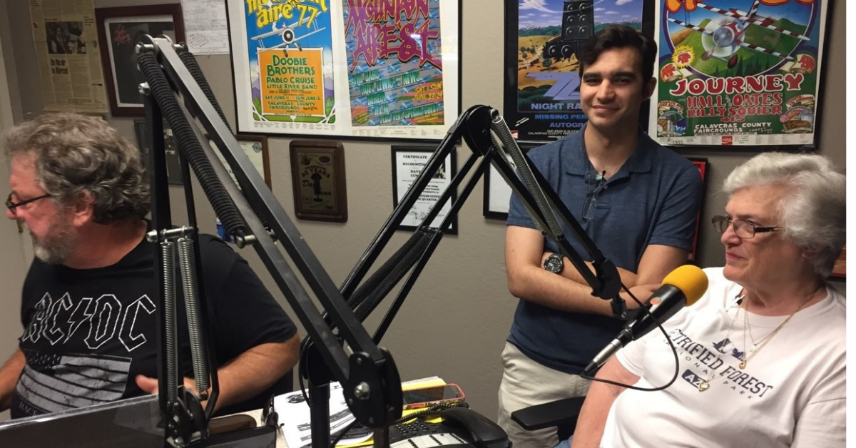 KYOS Audio Engineer Casey Stead checks microphones for two guests on Community Conversations. Photo- Steve Newvine