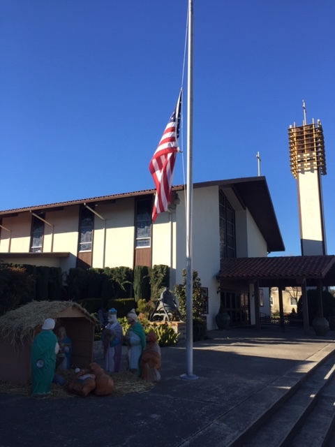 St. Joachim Catholic Church on Main Street in Newman, Stanislaus County. Like many properties displaying American flags in Newman, the flag in front of the Church is flying at half-staff in honor of Police Corporal Ronil Singh. Photo- Steve Newvine