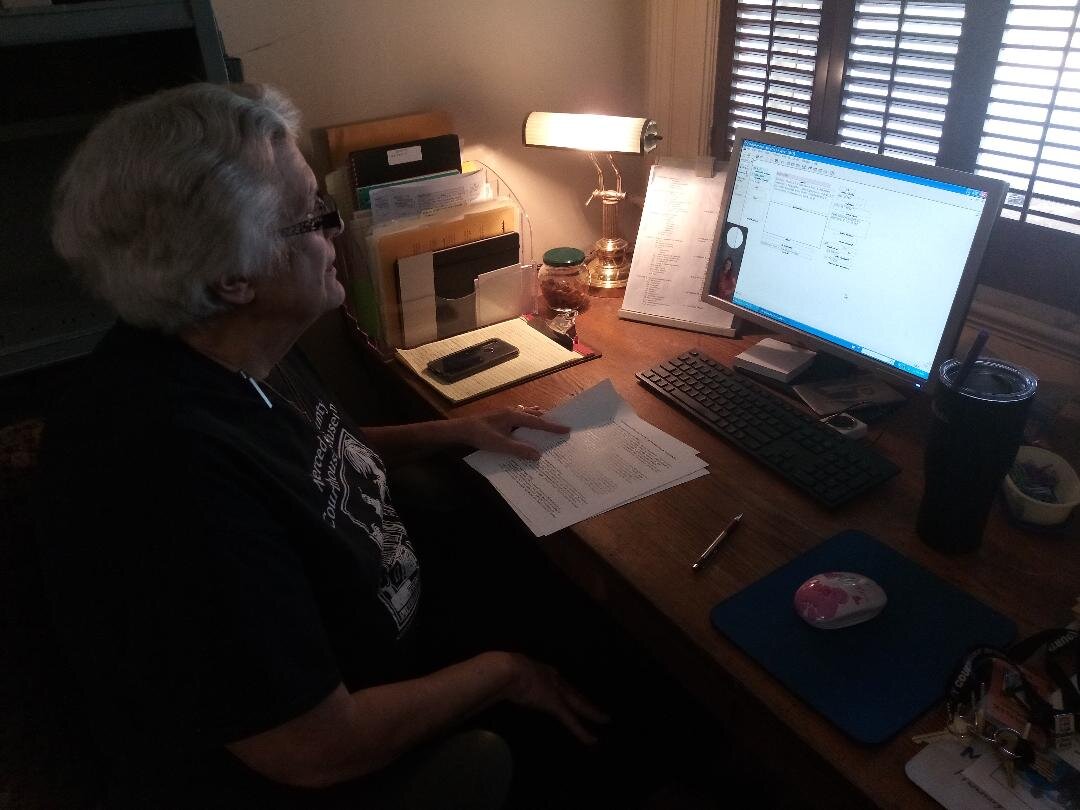 Museum Registrar Donna Lee Hartman records each photo from the Sun Star acquisition along with related information into the Museum’s computer. The process is referred to as accessioning. Photo: Steve Newvine