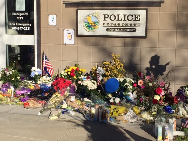 Flowers from all over California have been sent to the Newman Police Department. All the arrangements are on display in front of the Department headquarters on Main Street. Photo- Steve Newvine