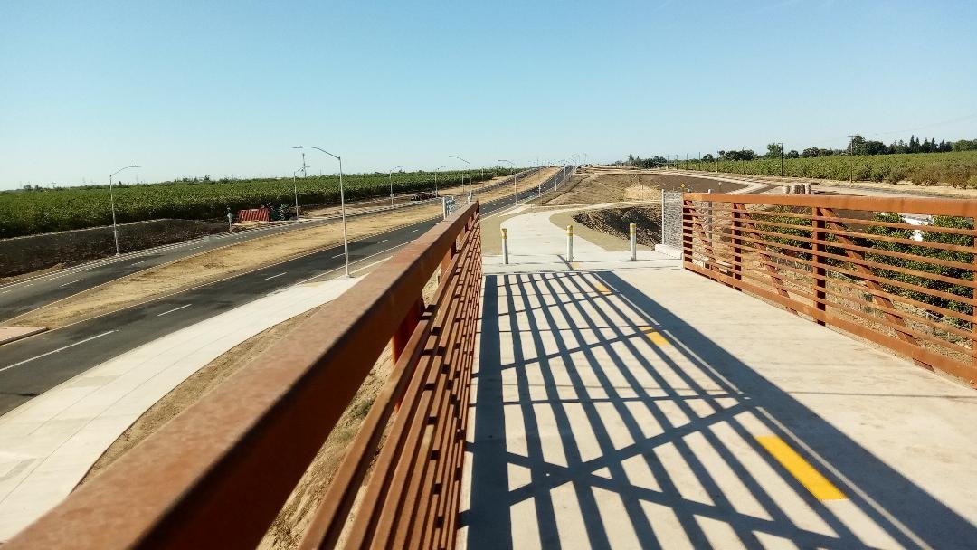 The view from the new bike/pedestrian bridge over the Olive Avenue roundabout section of Campus Parkway. Photo: Steve Newvine