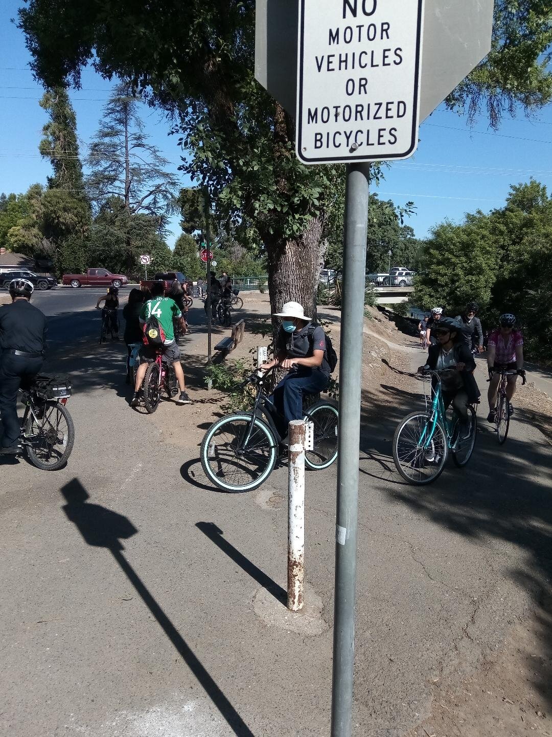 The group stopped at G Street to change sides from South to North Bear Creek. The switching of sides was made much safer with the Merced Police escort. Photo: Steve Newvine