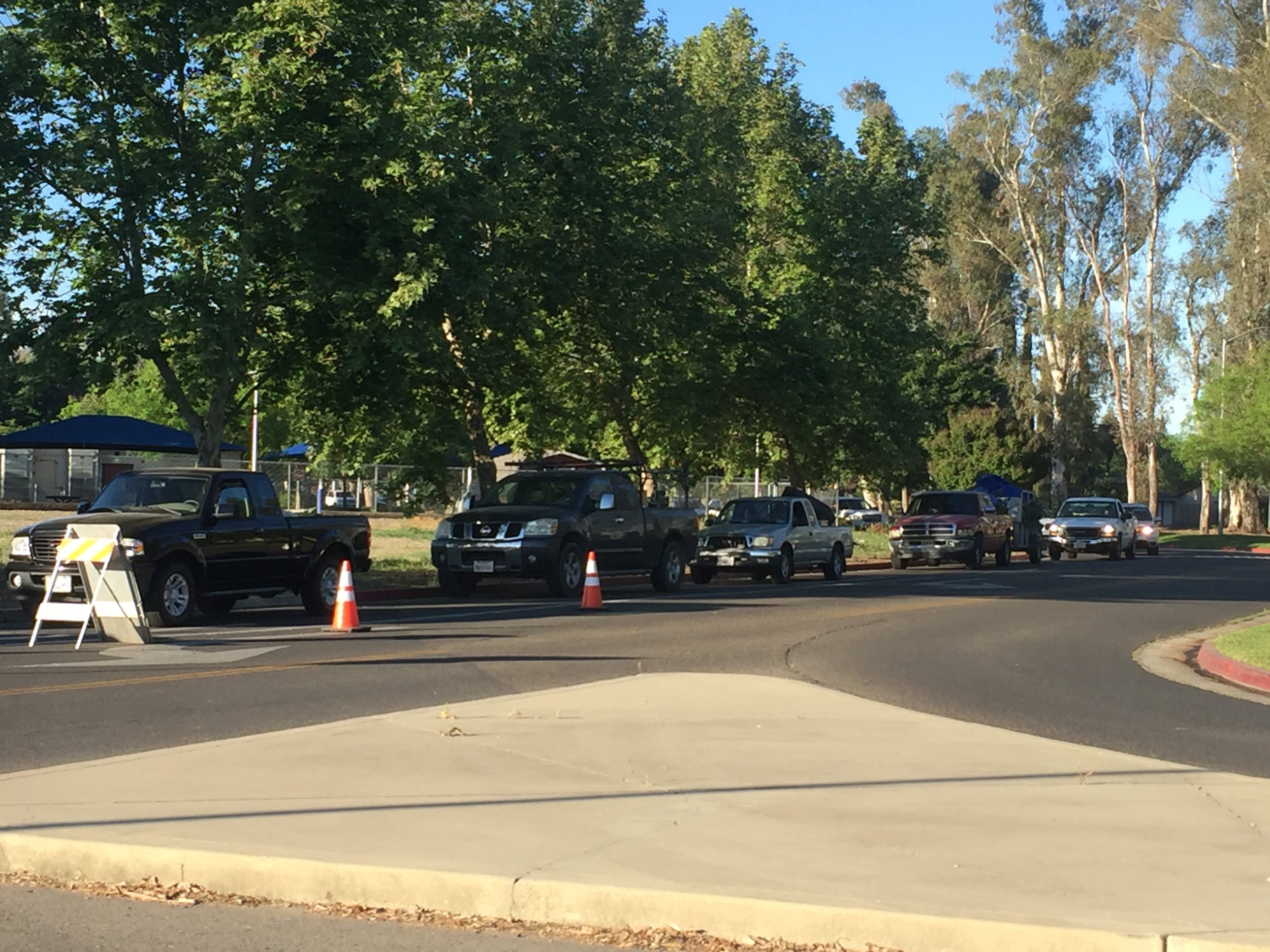 A steady stream of vehicles loaded with household junk moves along the access road parallel to M Street at Merced College for Spring Clean-Up Days. Photo: Steve Newvine
