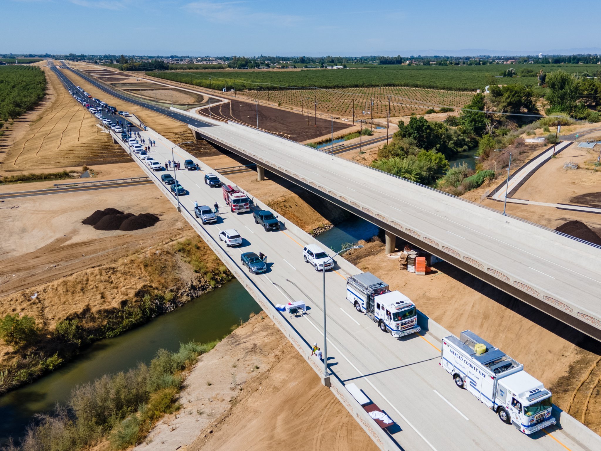 A drone eye view of the new highway taken on the day of the dedication. Following the ribbon cutting, two Cal Fire engines led the way for the stream of vehicles belonging to attendees at the ceremony. Photo: Merced County Facebook page.