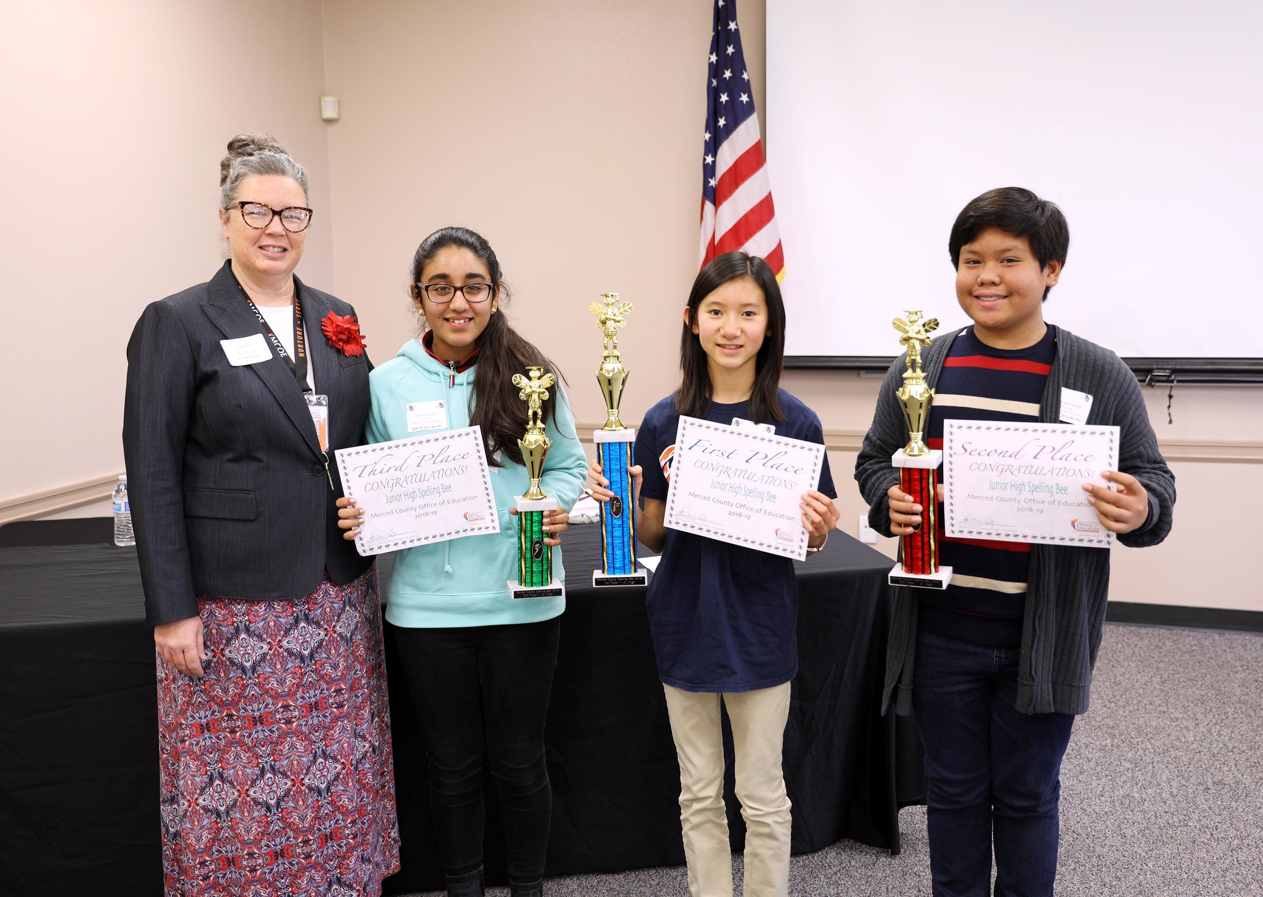 Junior High Spelling Bee Wordmaster Audry Garza, a coordinator at MCOE, poses with third place winner Samika Judge, first place winner Nicole Nguyen and second place winner Luke Almeada. Photo: Nate Gnomes, Merced County Office of Education