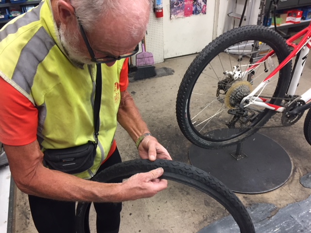 Francois inspects the tire that was damaged on his bicycle. His tire and wheel were fixed at Kevin’s Bikes in Merced and he was on his way after a couple of hours. Photo: Steve Newvine.